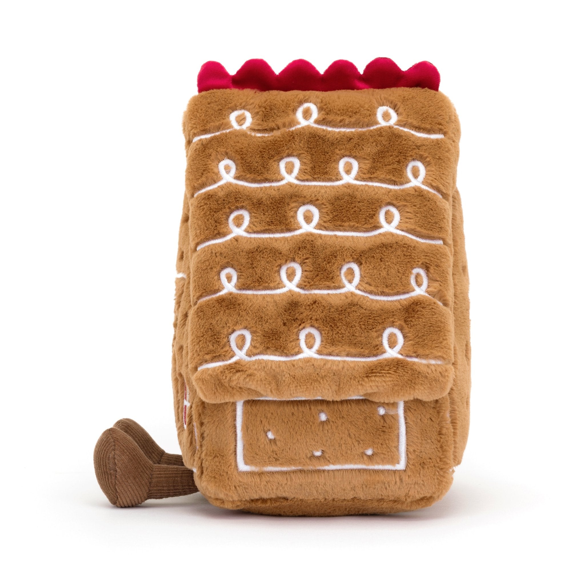 Amuseables Gingerbread House - TAYLOR + MAXJellycat - A smiling brown, stuffed gingerbread house with brown legs turned to the side