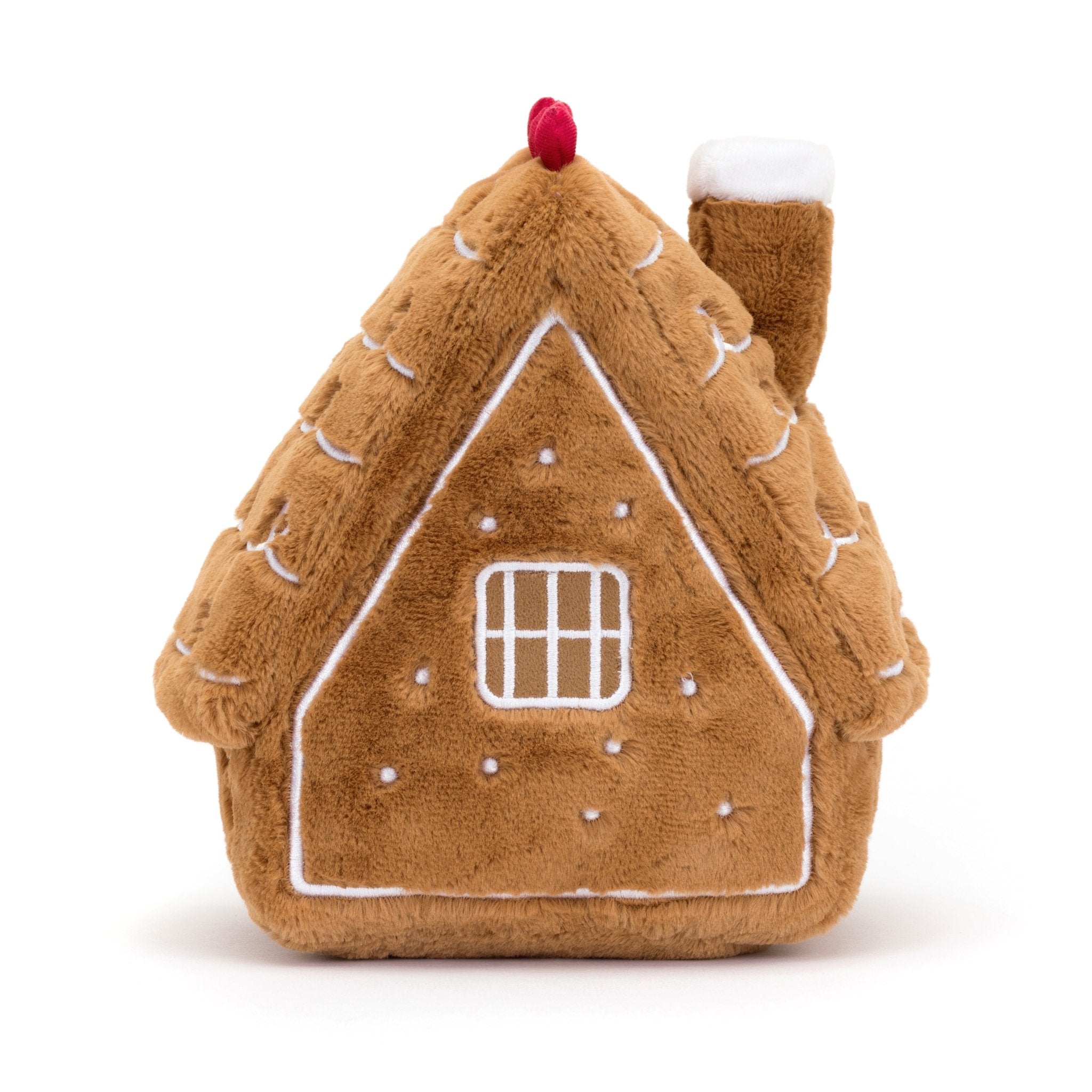 Amuseables Gingerbread House - TAYLOR + MAXJellycat - A smiling brown, stuffed gingerbread house with brown legs with its back facing the camera